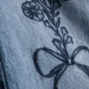 7–15 år | Jeans med brede ben og broderet blomsterbue