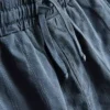 7-15 år | sæt bestående af kortærmet skjorte med knapper og shorts i strukturvævet stof