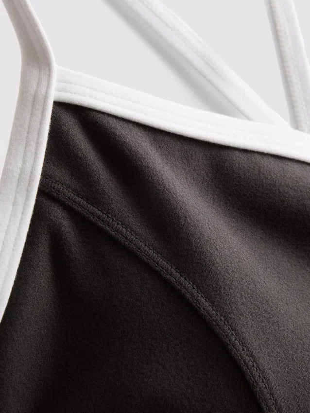 Aktiv crop-top med kontrastkant og krydsryg