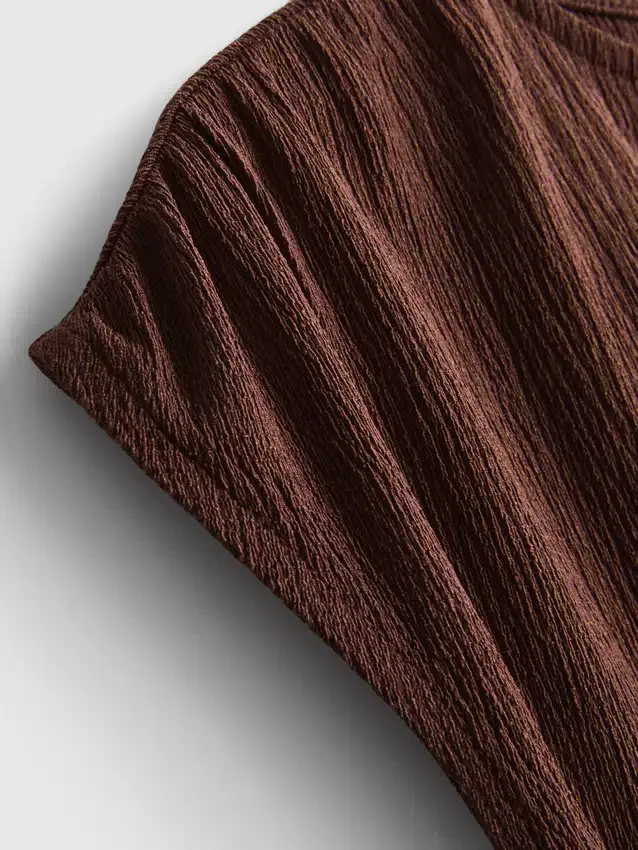 Asymmetrisk krøllet top