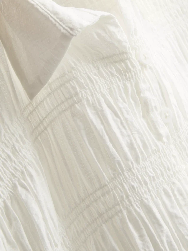 Bluse med rynket peplum-kant