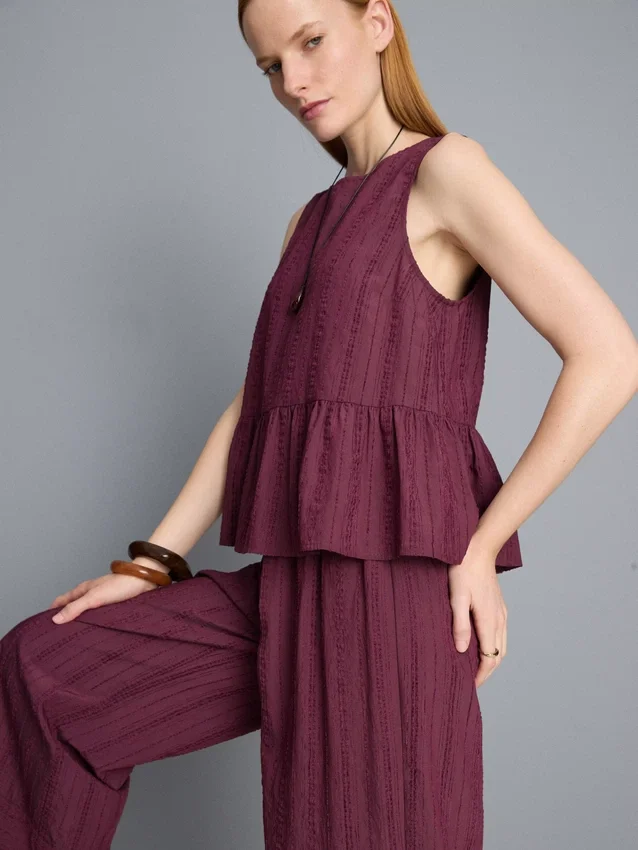 Stribet tanktop med peplum-kant