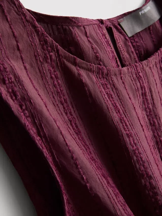 Stribet tanktop med peplum-kant