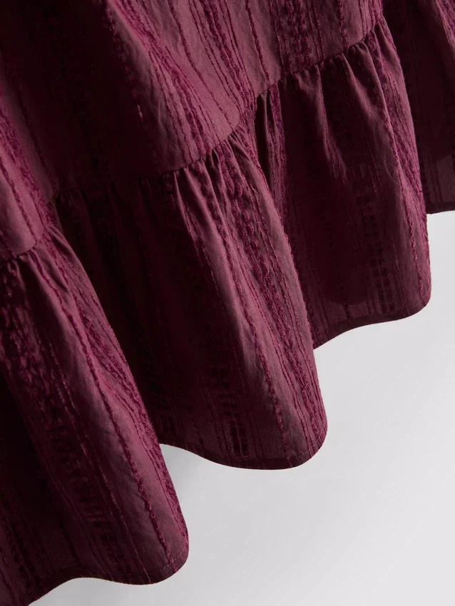 Stribet tanktop med peplum-kant